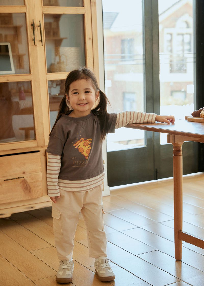 baby girl stand beside the table