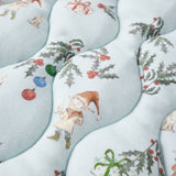 Patterned fabric with Christmas-themed designs including elves, presents, and holly leaves on a light blue background.