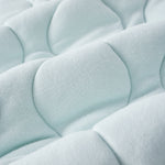 Close-up of a textured light blue fabric surface