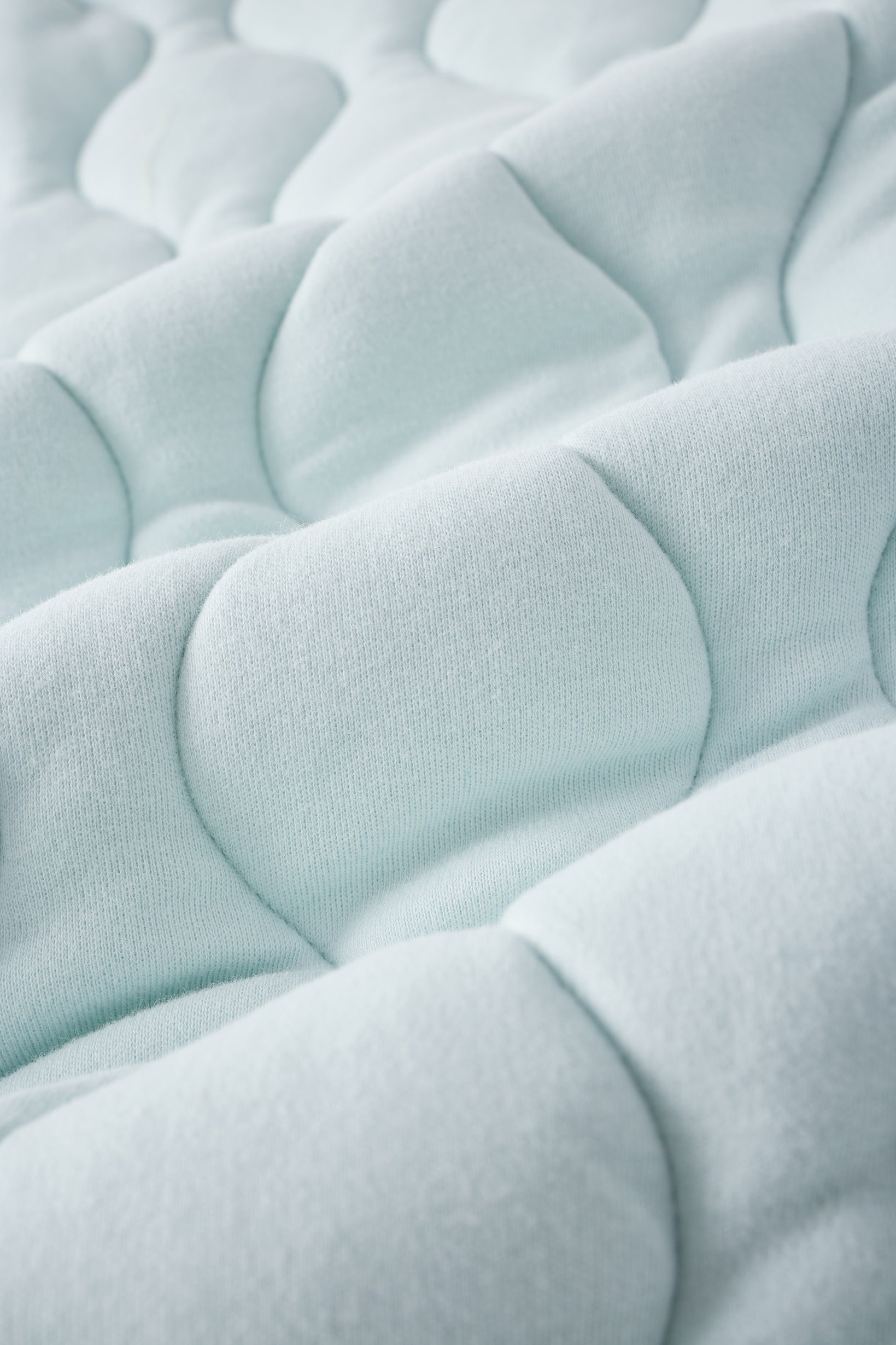 Close-up of a textured light blue fabric surface
