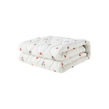 Folded white blanket with red patterns on a white background