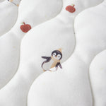 White fabric with penguin and apple pattern