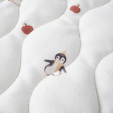 White fabric with penguin and apple pattern