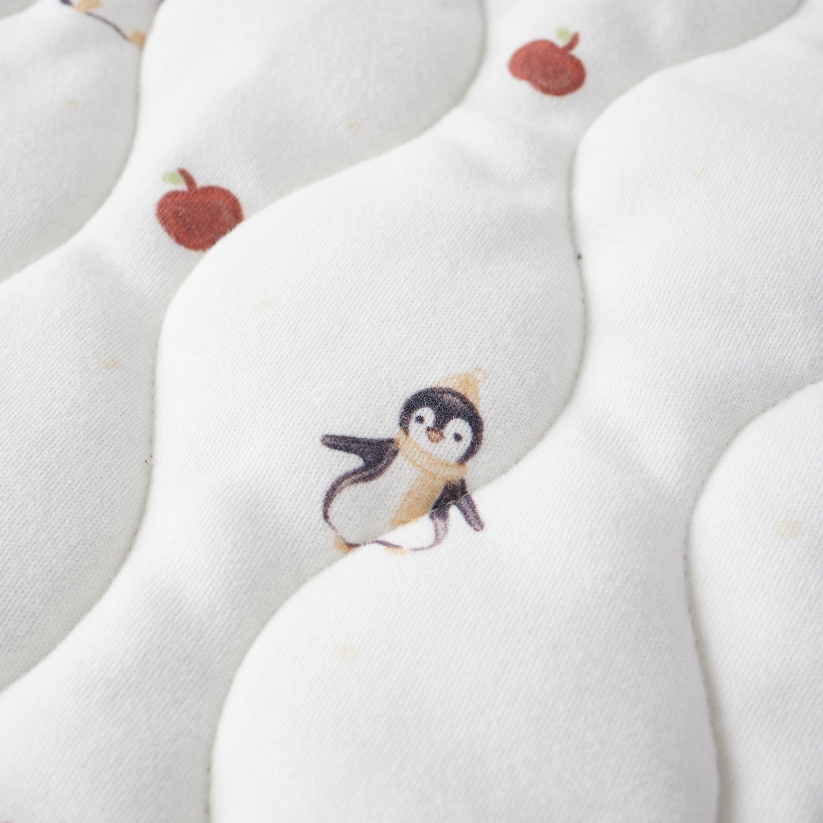 White fabric with penguin and apple pattern