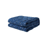 Folded blue quilt with a subtle pattern on a white background