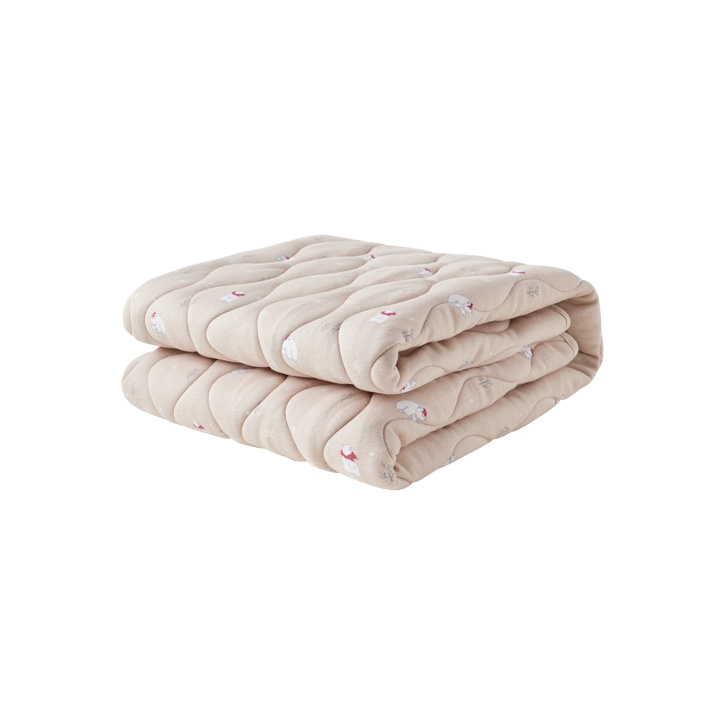 Folded beige quilt on a white background