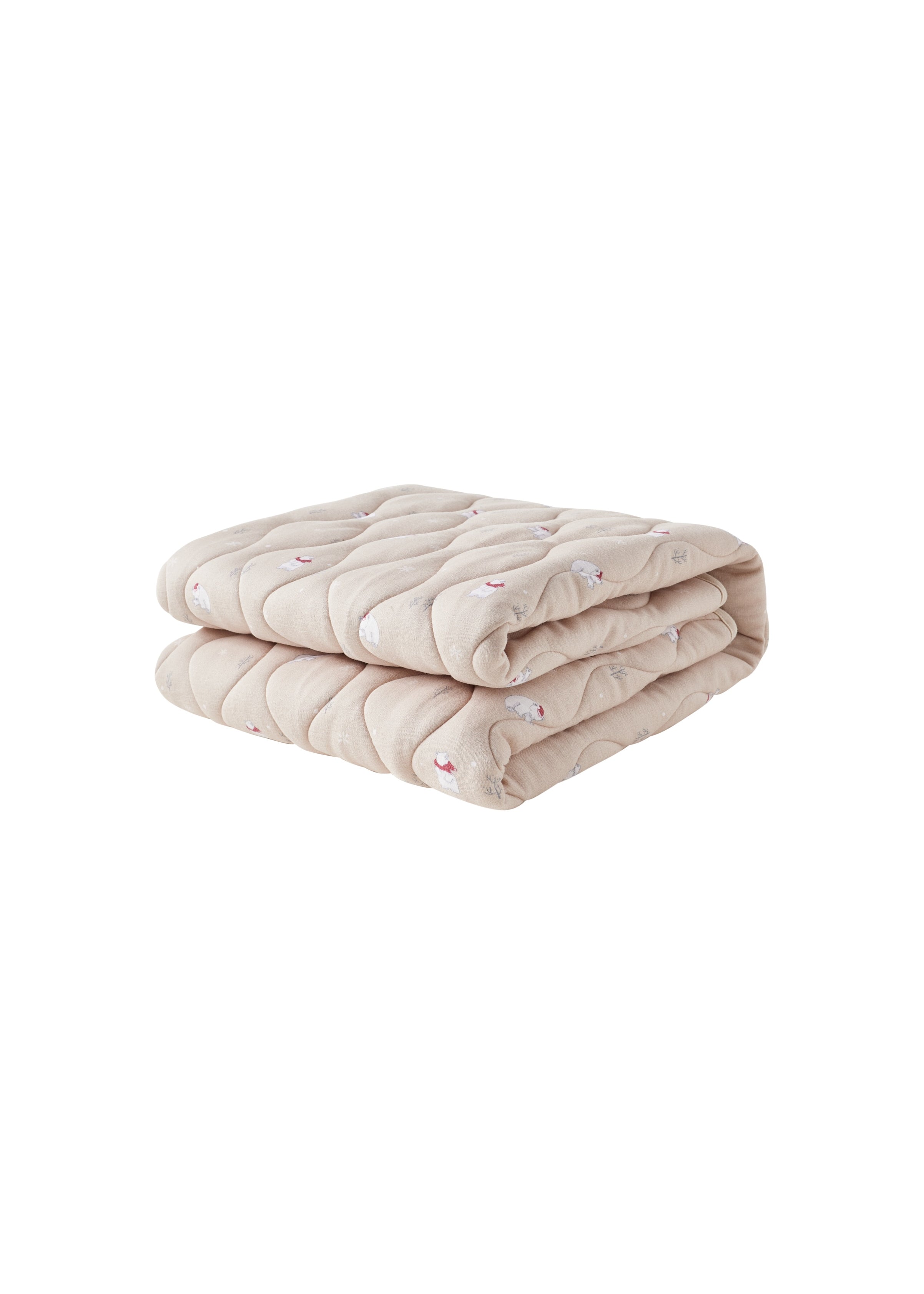 Folded beige quilt on a white background