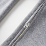Close-up of a gray zip-up hoodie on a white background