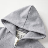 Gray hoodie with a brand label on a white background