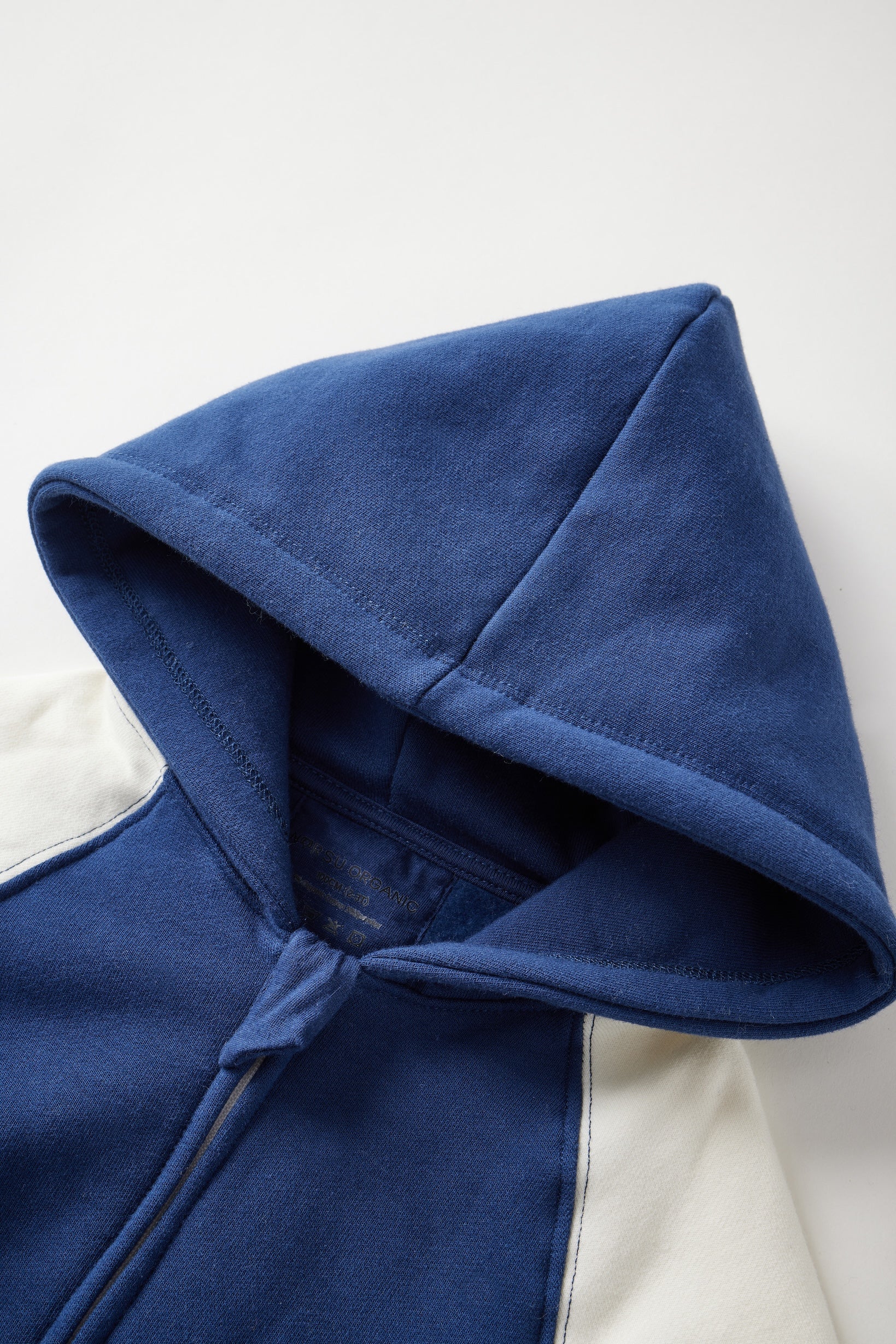 Close-up of a blue hooded garment on a white background