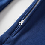 Close-up of a blue jacket with a zipper on a light gray background