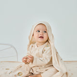 baby sitting on the bed and smilling to the camera