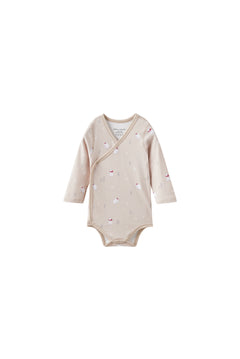 Beige baby onesie with polar bear patterns on a white background