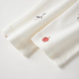 sleeper's sleeve with red floral embroidery on a light gray background