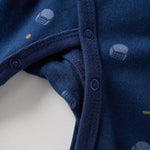 Close-up of a blue baby sleeper with small patterns on a white background