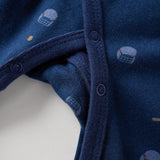 Close-up of a blue baby sleeper with small patterns on a white background