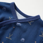 Close-up of a blue baby outfit with patterns on a white background