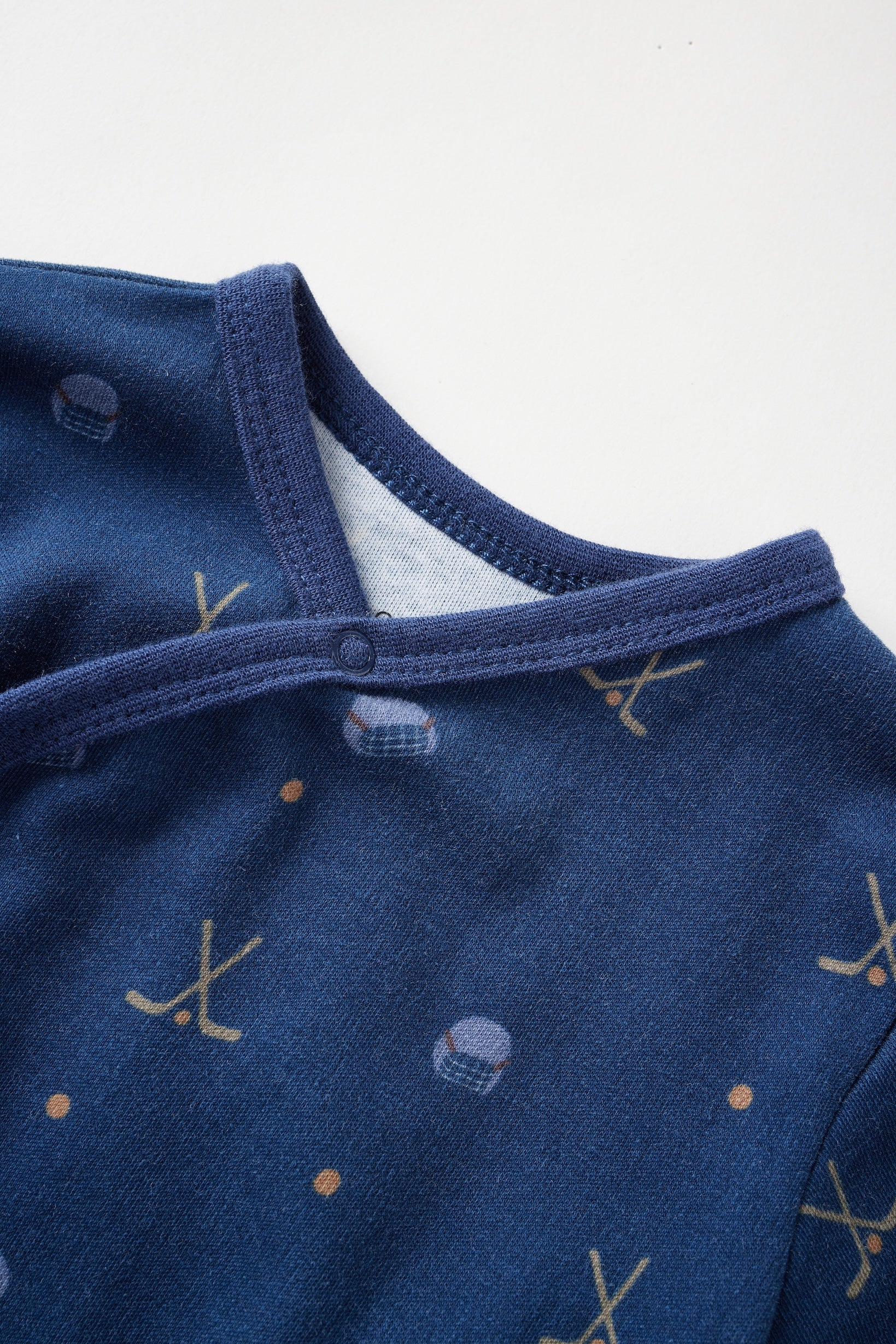 Close-up of a blue baby outfit with patterns on a white background