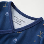 Close-up of a blue baby outfit with a label on a white background