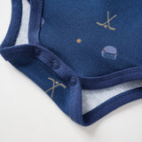 Navy blue baby onesie with pattern on a white background