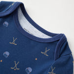 Blue baby onesie with hockey pattern on a white background