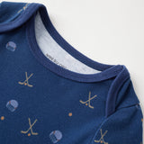 Blue baby onesie with hockey pattern on a white background