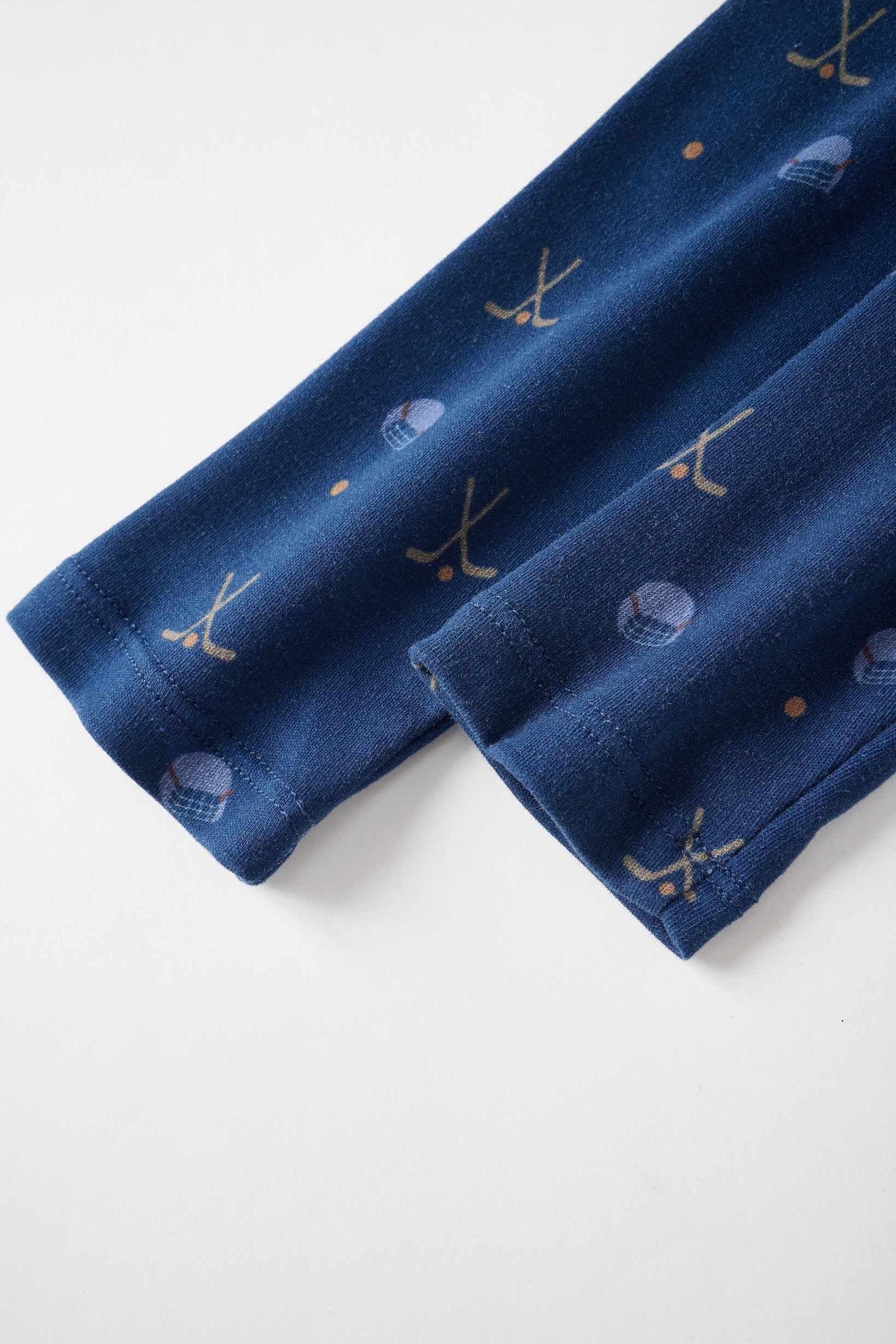 onesie sleeve with sports-themed embroidery on a white background