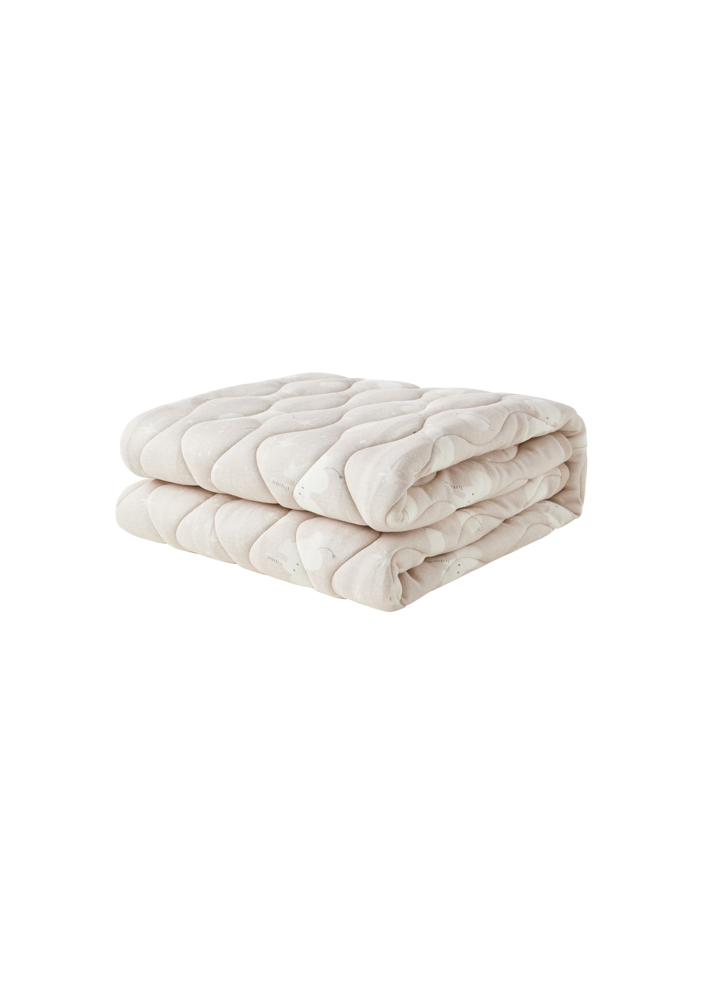 Folded beige quilt on a white background