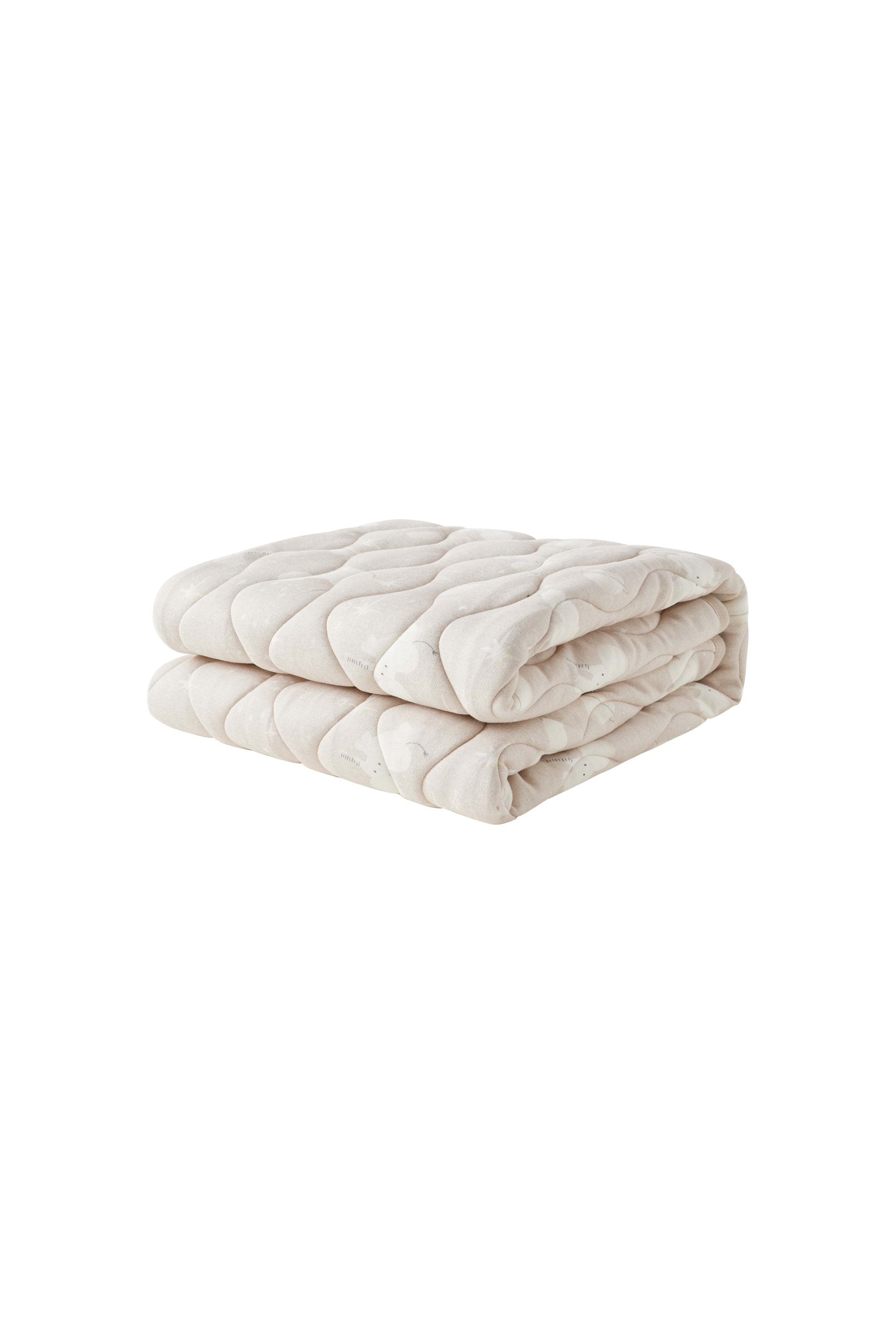 Folded beige quilt on a white background