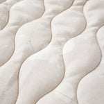 Close-up of a textured blanket surface with patterns.