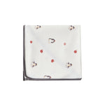 White swaddle blanket with red and black patterns on a white background