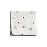 White swaddle blanket with red and black patterns on a white background