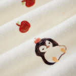 Embroidered penguin design on a white fabric background