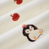 Embroidered penguin design on a white fabric background