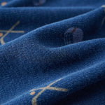 Close-up of blue fabric with gold embroidery