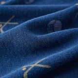 Close-up of blue fabric with gold embroidery