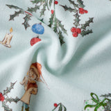 Fabric with Christmas-themed design featuring holly, berries, and a small figure on a light blue background.