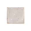 Beige blanket with red and white floral patterns on a white background