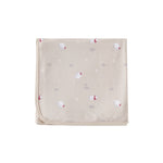 Beige blanket with red and white floral patterns on a white background