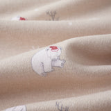 Close-up of beige fabric with embroidered polar bears and plants.