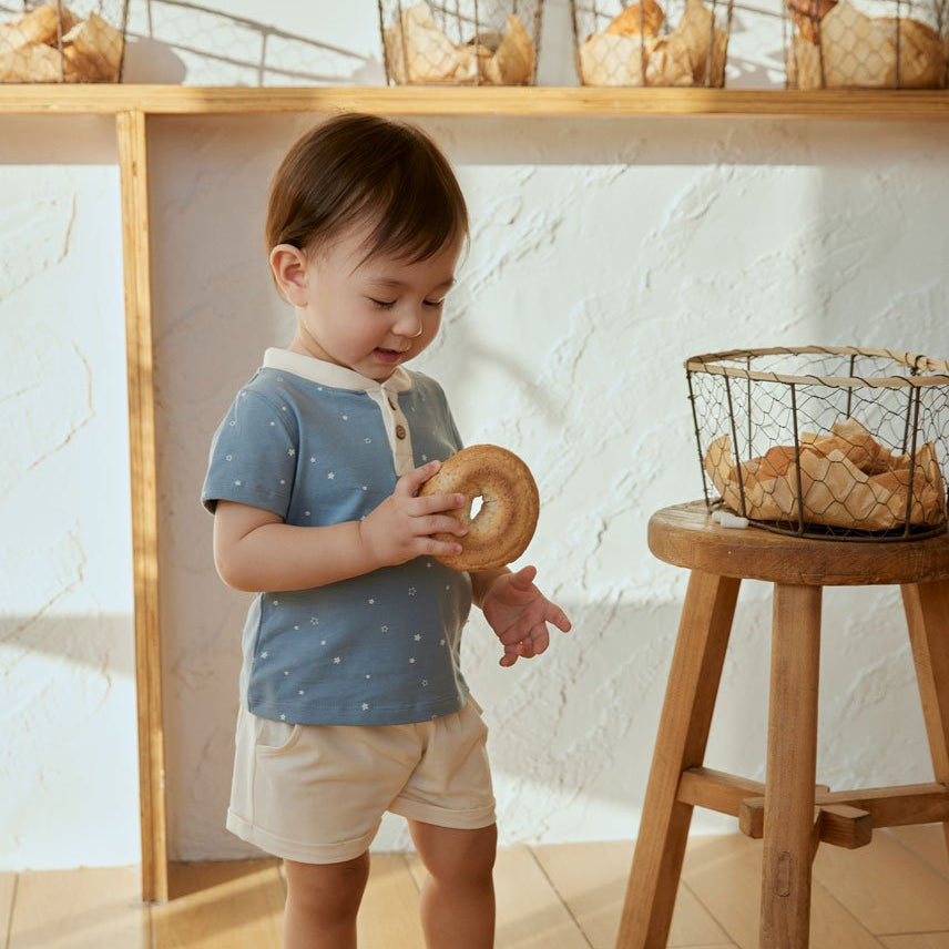 baby boy look at the bagel and smiling