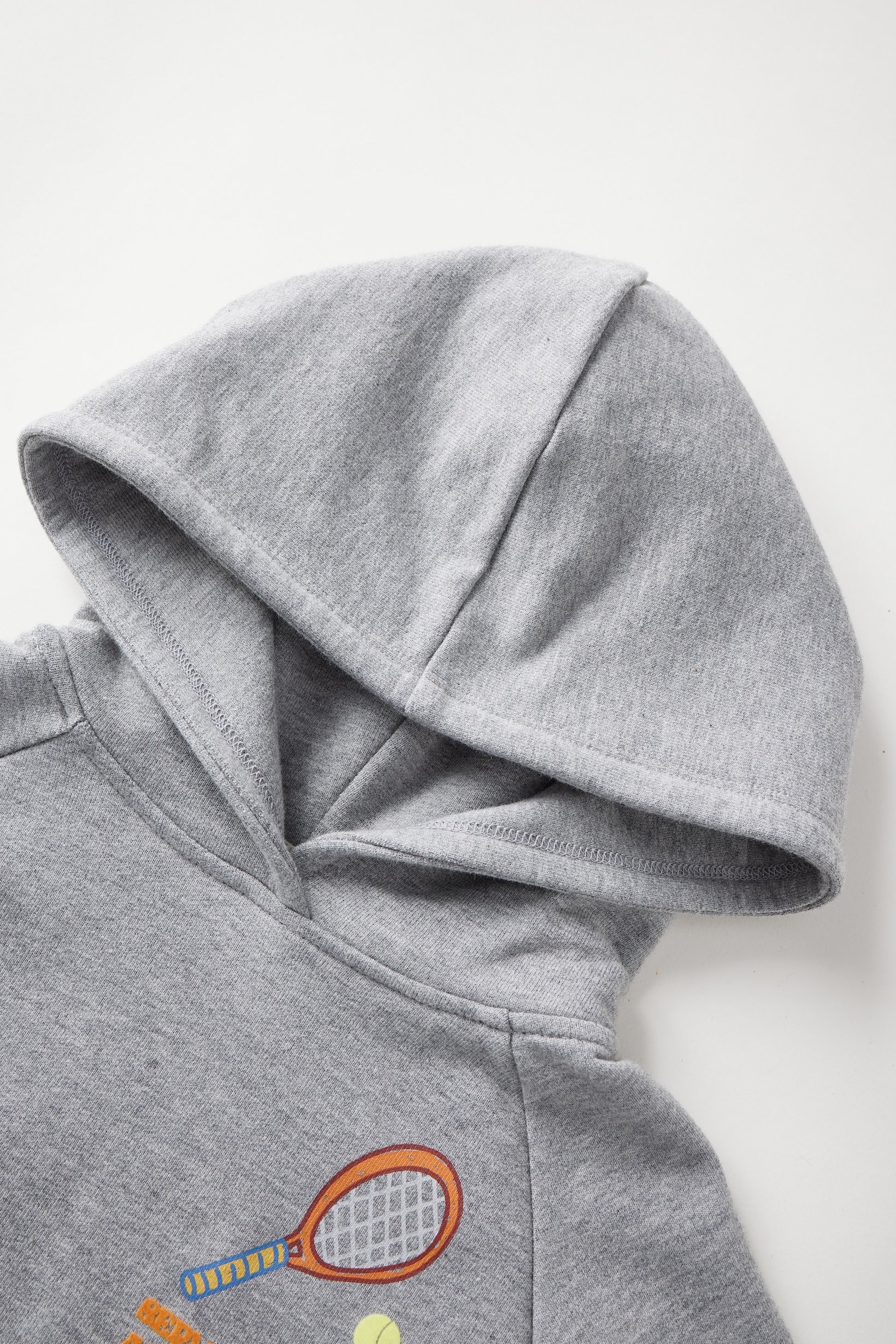 Gray hoodie with tennis racket and ball design on a white background