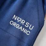 Blue fabric with 'NORSU ORGANIC' text on a neutral background