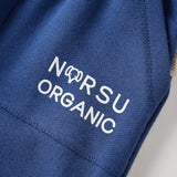 Blue fabric with 'NORSU ORGANIC' text on a neutral background