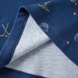 Close-up of a blue fabric with sports-themed embroidery on a white background