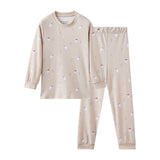 Beige pajama set with small patterns on a white background