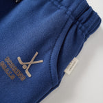 Blue sweatpants with hocket print and text on a light gray background