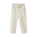 Beige sweatpants with a logo on a white background