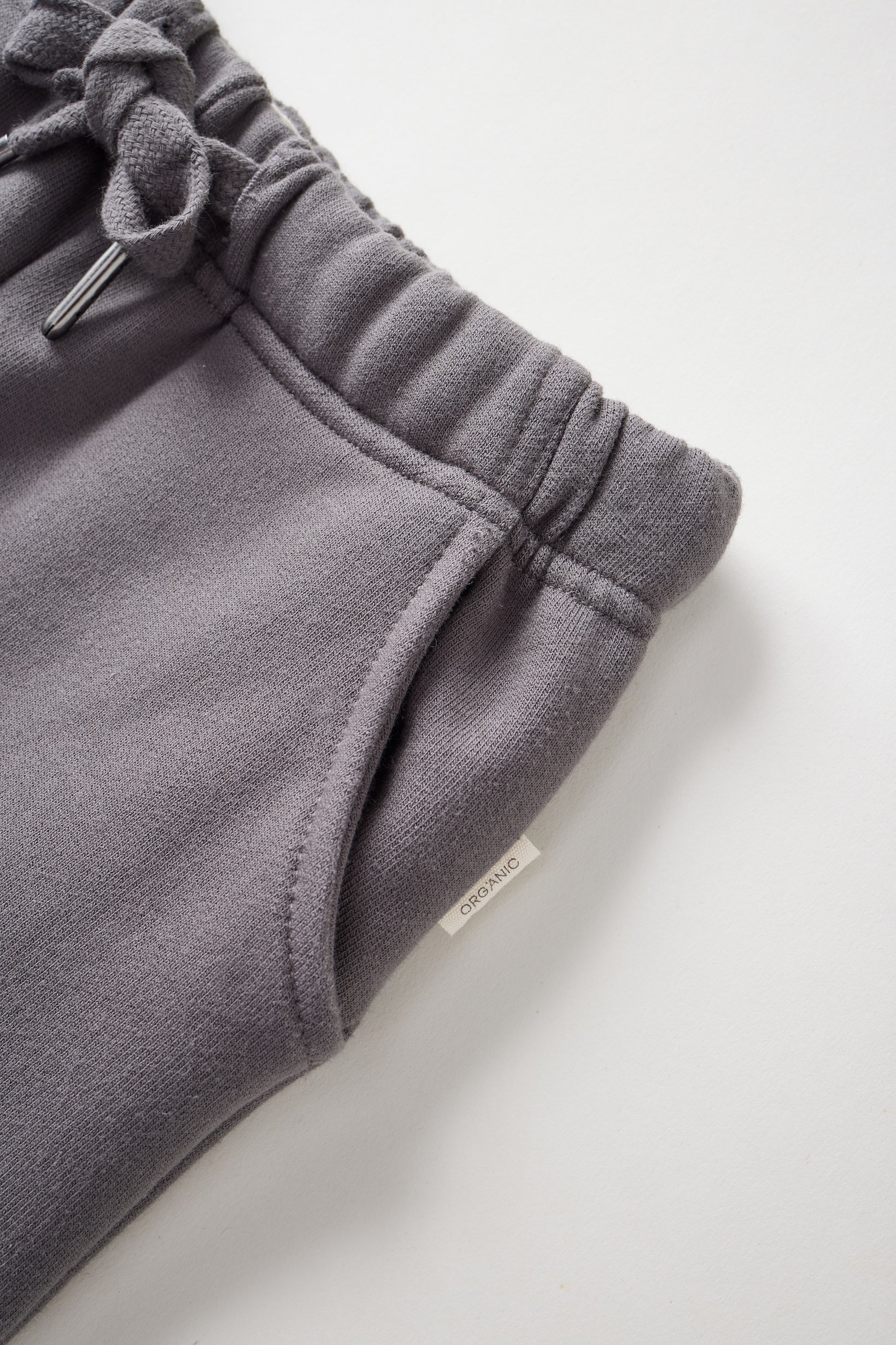 Gray sweatpants with drawstring on a light gray background