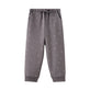 Gray sweatpants with small white patterns on a white background